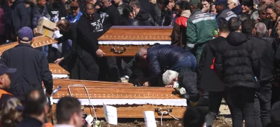 A man cries leaning on a coffin during the funeral ceremony of the victims of a massive nightclub fire in the town of Kocani, North Macedonia, Thursday, March 20, 2025. (AP Photo/Armin Durgut)