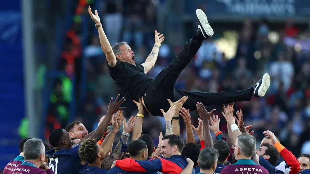 Soccer Football - Ligue 1 - Paris St Germain v Angers - Parc des Princes, Paris, France - April 5, 2025 Paris St Germain coach Luis Enrique celebrates with the players after winning Ligue 1 REUTERS/Gonzalo Fuentes   TPX IMAGES OF THE DAY