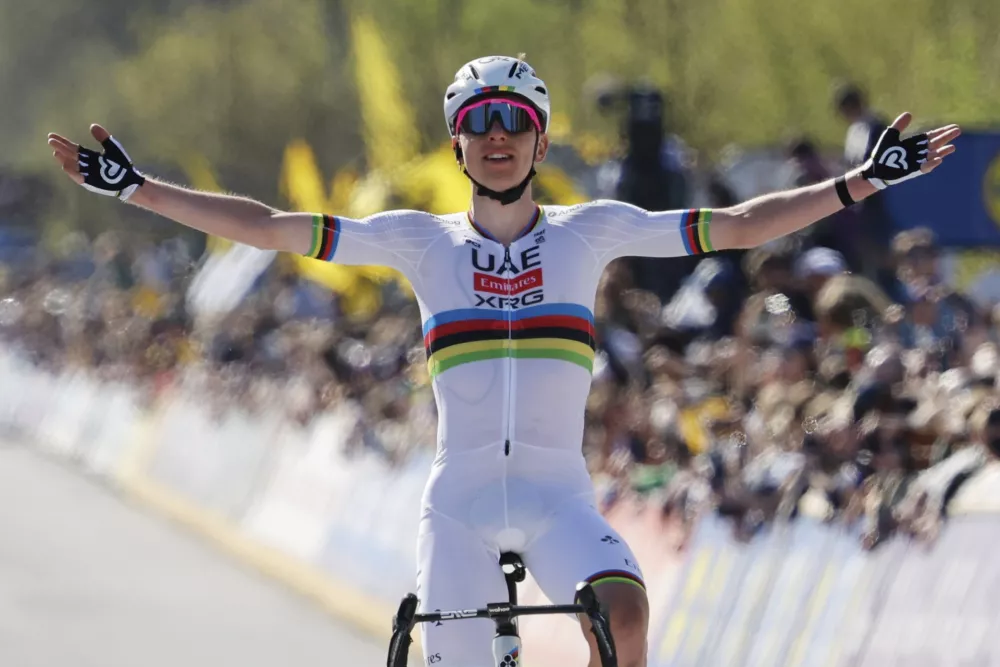 Slovenia's Tadej Pogacar, of the UAE Team Emirates XRG, crosses the finish line to win the Tour of Flanders in Oudenaarde, Belgium on Sunday, April 6, 2025. (AP Photo/Geert Vanden Wijngaert)