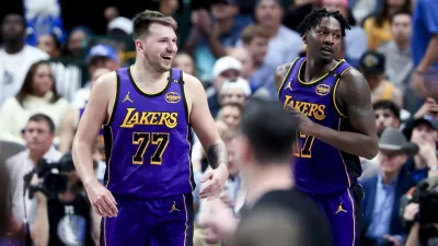 Apr 9, 2025; Dallas, Texas, USA; Los Angeles Lakers guard Luka Doncic (77) laughs with Los Angeles Lakers forward Dorian Finney-Smith (17) against the Dallas Mavericks during the second half at American Airlines Center. Mandatory Credit: Kevin Jairaj-Imagn Images