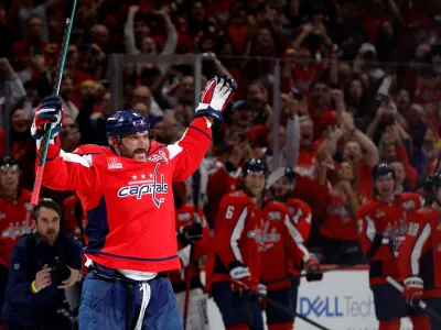 Apr 4, 2025; Washington, District of Columbia, USA; Washington Capitals left wing Alex Ovechkin (8) waves to the crowd from center ice after scoring his 894th career goal on a goal against the Chicago Blackhawks in the third period at Capital One Arena. Ovechkin tied Wayne Gretzky (not pictured) for the all time record for career goal with the goal. Mandatory Credit: Geoff Burke-Imagn Images   TPX IMAGES OF THE DAY