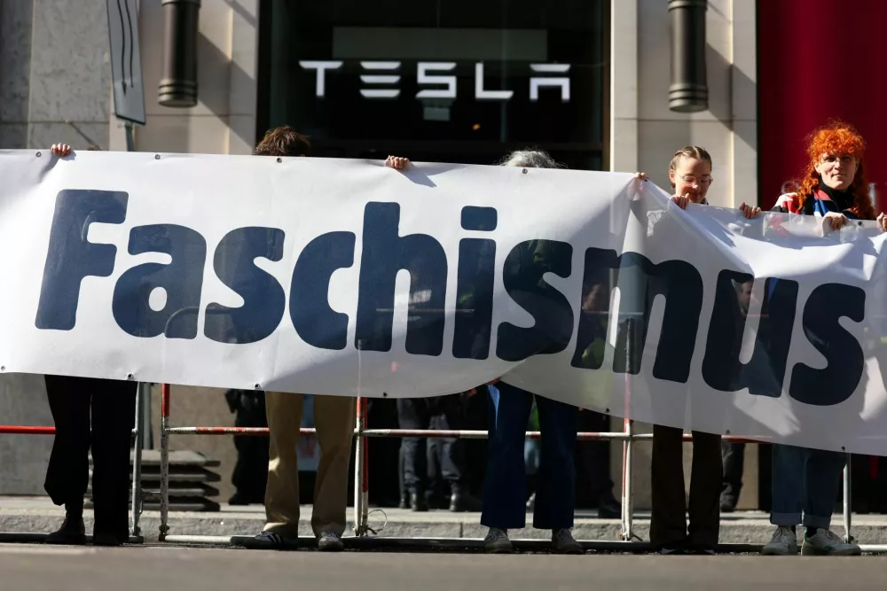 People take part in a protest outside a Tesla showroom at Mall of Berlin under the slogan "#TeslaTakedown" against Tesla and its CEO Elon Musk and against what organisers say is the destruction of democracy and the climate by the rich, in Berlin, Germany, April 5, 2025. REUTERS/Christian Mang