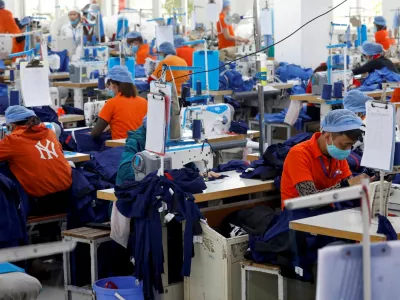FILE PHOTO: Labourers work at Hung Viet garment export factory in Hung Yen province, Vietnam December 30, 2020. REUTERS/Kham/File Photo