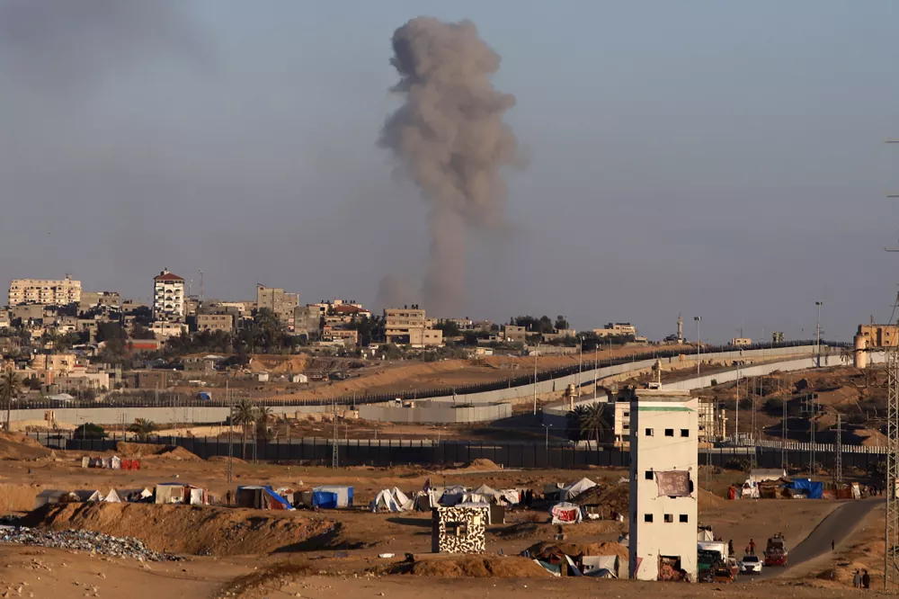 Smoke rises following an Israeli airstrike on buildings near the separating wall between Egypt and Rafah, southern Gaza Strip, Monday, May 6, 2024. (AP Photo/Ramez Habboub)