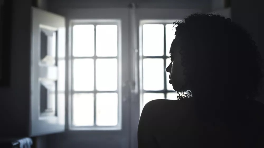 Naked silhouette woman looking by a vintage window. / Foto: David-prado