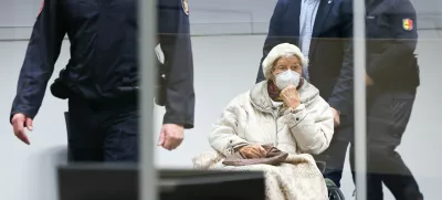 FILED - 20 December 2022, Itzehoe: The defendant Irmgard F.,charged with aiding mass murder in over 11,000 cases in the Stutthof concentration camp, is brought into the courtroom at the beginning in Itzehoe. The 99-year-old former secretary at the Stutthof concentration camp convicted for aiding and abetting the mass murder of more than 10,000 people between June 1943 and April 1945 has died, prosecutors said on Monday. Photo: Christian Charisius/dpa/Pool/dpa