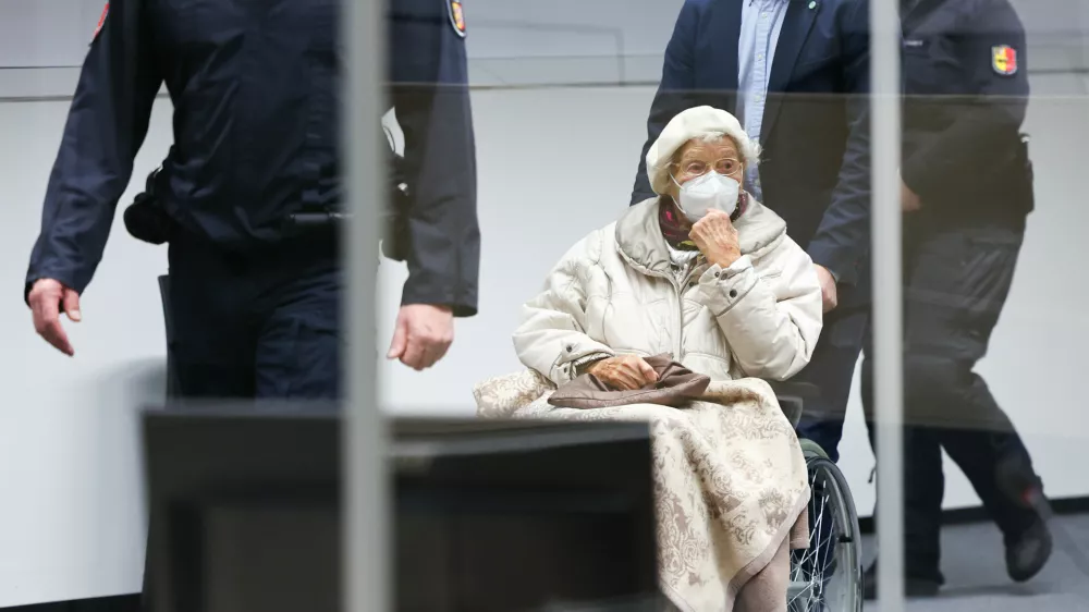 FILED - 20 December 2022, Itzehoe: The defendant Irmgard F.,charged with aiding mass murder in over 11,000 cases in the Stutthof concentration camp, is brought into the courtroom at the beginning in Itzehoe. The 99-year-old former secretary at the Stutthof concentration camp convicted for aiding and abetting the mass murder of more than 10,000 people between June 1943 and April 1945 has died, prosecutors said on&nbsp;Monday. Photo: Christian Charisius/dpa/Pool/dpa
