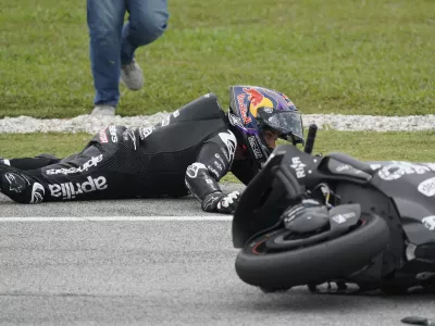 Aprilia Racing's Spanish rider Jorge Martin crashes on second corner during the first day of the 2025 MotoGP pre-season test at the Sepang International Circuit in Sepang, Malaysia, Wednesday, Feb. 5, 2025. (AP Photo/Kien Huo)
