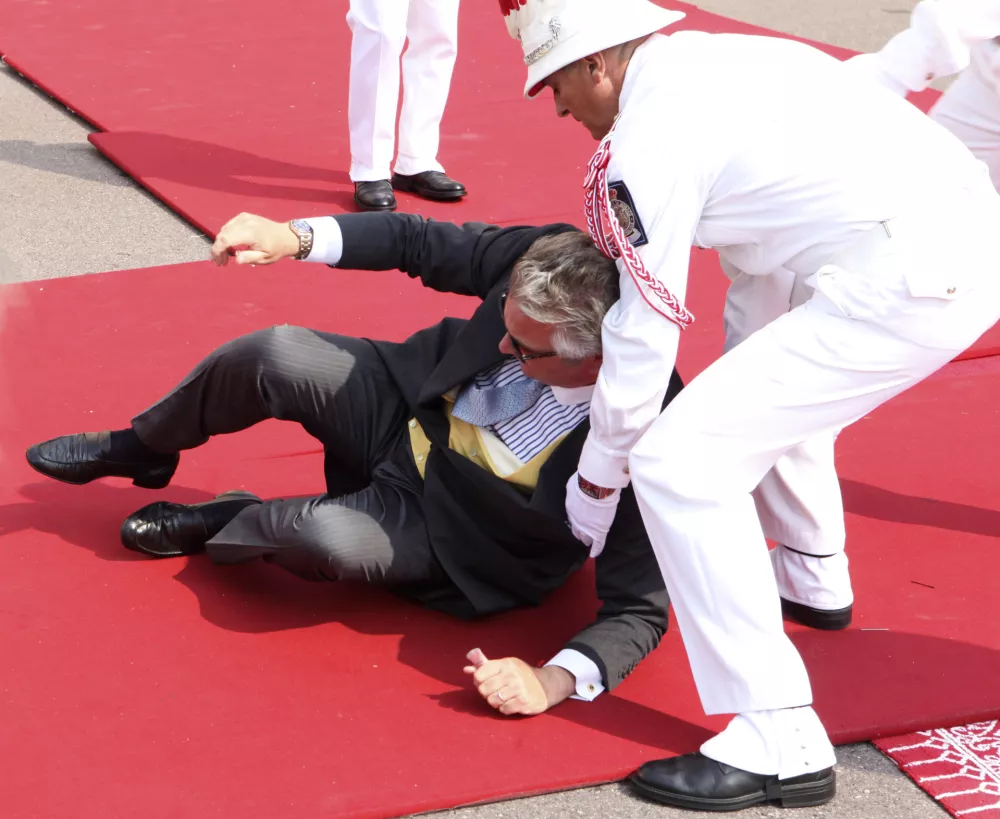 Prince Laurent of Belgium falls as he arrives at the Monaco palace for the religious wedding ceremony of Prince Albert II of Monaco and Charlene Princess of Monaco, Saturday, July 2, 2011. (AP Photo/Joel Ryan, Pool)