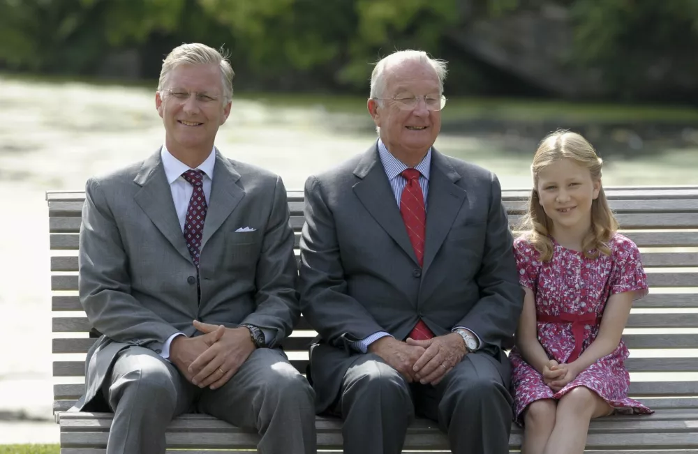 Belgium's royal family (L-R) Crown Prince Philippe, King Albert II and Princess Elisabeth pose for a photo at the private garden of Laeken castle in Brussels in this September 2, 2012 file photo. The king will give a televised address to the nation on July 3, 2013, the royal palace said, amid frenzied speculation in the local media that the 79-year-old monarch will step down.   REUTERS/Laurent Dubrule/Files (BELGIUM - Tags: PROFILE ROYALS)