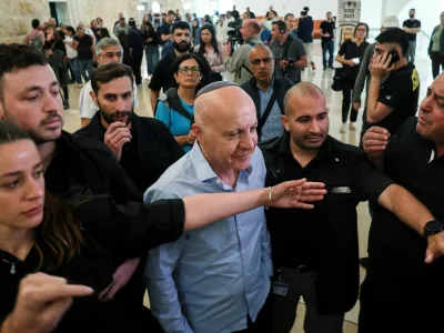 Former head of Israel's Shin Bet domestic intelligence service Yoram Cohen is guarded by the court security personnel, as he walks out from the courtroom during a hearing on the government's dismissal of the head of the Shin Bet domestic intelligence service, Ronen Bar, at the high court in Jerusalem April 8, 2025. REUTERS/Ronen Zvulun