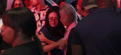 Relatives of missing people embrace while waiting at the National Institute of Forensic Pathology after the roof collapsed at Jet Set nightclub during a merengue concert in Santo Domingo, Dominican Republic, Tuesday, April 8, 2025. (AP Photo/Ricardo Hernandez)