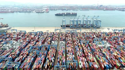 FILE PHOTO: An aerial view shows containers and cargo vessels at the Qingdao port in Shandong province, China May 9, 2022. Picture taken with a drone. China Daily via REUTERS ATTENTION EDITORS - THIS IMAGE WAS PROVIDED BY A THIRD PARTY. CHINA OUT./File Photo