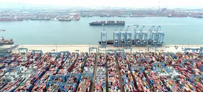 FILE PHOTO: An aerial view shows containers and cargo vessels at the Qingdao port in Shandong province, China May 9, 2022. Picture taken with a drone. China Daily via REUTERS ATTENTION EDITORS - THIS IMAGE WAS PROVIDED BY A THIRD PARTY. CHINA OUT./File Photo