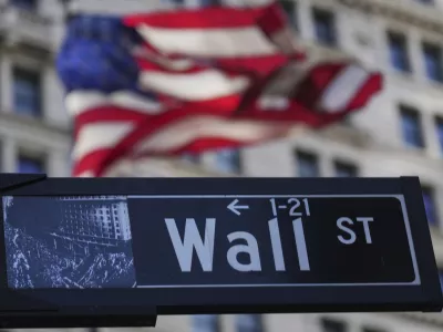 A Wall St. sign is seen near the New York Stock Exchange in New York, Tuesday, April 8, 2025. (AP Photo/Seth Wenig)