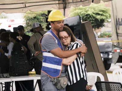 A rescue worker comforts a woman during the search for survivors at the Jet Set nightclub after its roof collapsed two nights prior during a merengue concert in Santo Domingo, Dominican Republic, Wednesday, April 9, 2025. (AP Photo/Ricardo Hernandez)
