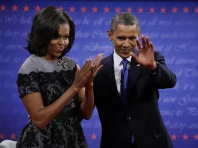 President Barack Obama and Michelle wave to members of the audience following the third presidential debate with Republican presidential nominee Mitt Romney at Lynn University, Monday, Oct. 22, 2012, in Boca Raton, Fla. (AP Photo/David Goldman)