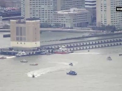 This aerial image taken from video shows rescue vessels on site of helicopter crash on the Hudson River in New York, Thursday, April 10, 2025. (WABC-TV via AP)