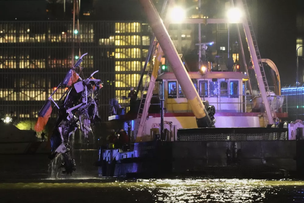 A crane vessel lifts the wreckage of a helicopter that crashed into the Hudson River, Thursday, April 10, 2025, in Jersey City, N.J. (AP Photo/Seth Wenig)