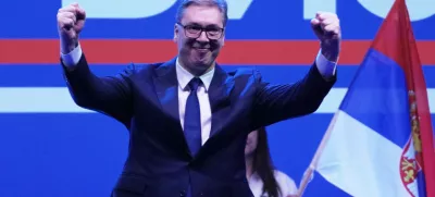 Serbia's President Aleksandar Vucic greets his supporters gathered during a huge rally in his support, apparently designed to counter student-led gatherings in Belgrade, Serbia, Saturday, April 12, 2025. (AP Photo/Darko Vojinovic)