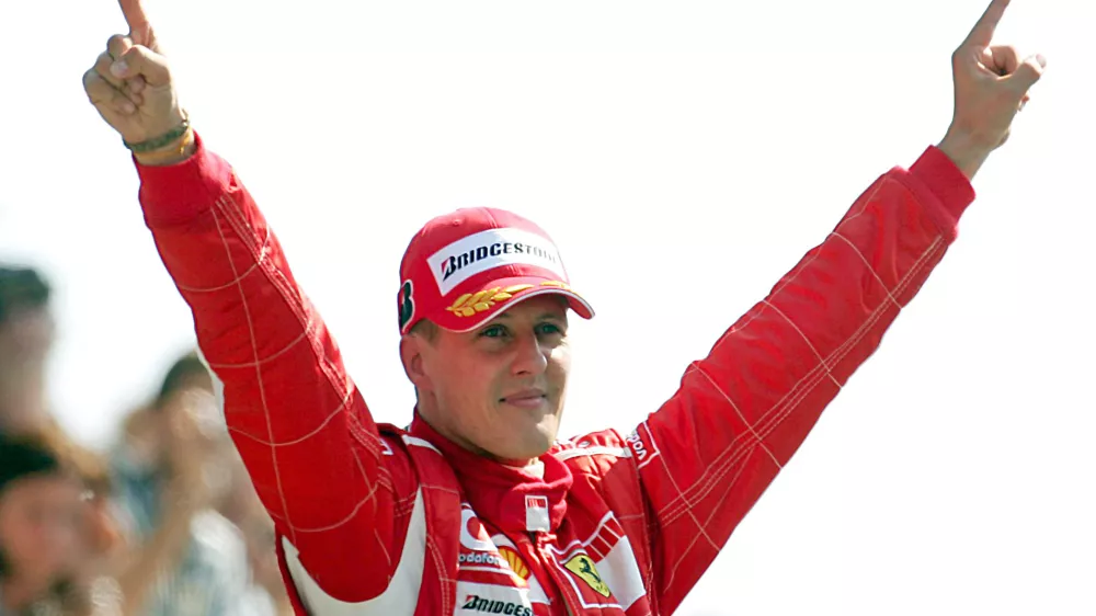FILED - 10 September 2006, Italy, Monza: Formula 1 legend Michael Schumacher, then of Scuderia Ferrari, celebrates his victory at the Italian Grand Prix in Monza. Schumacher has signed a crash helmet which will be auctioned for Jackie Stewart's dementia charity. Photo: Gero Breloer/dpa