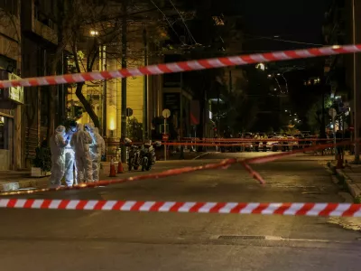 Forensics officers investigate the area of a bomb blast outside the Hellenic Train offices, in Athens, Greece, April 11, 2025. REUTERS/Stelios Misinas