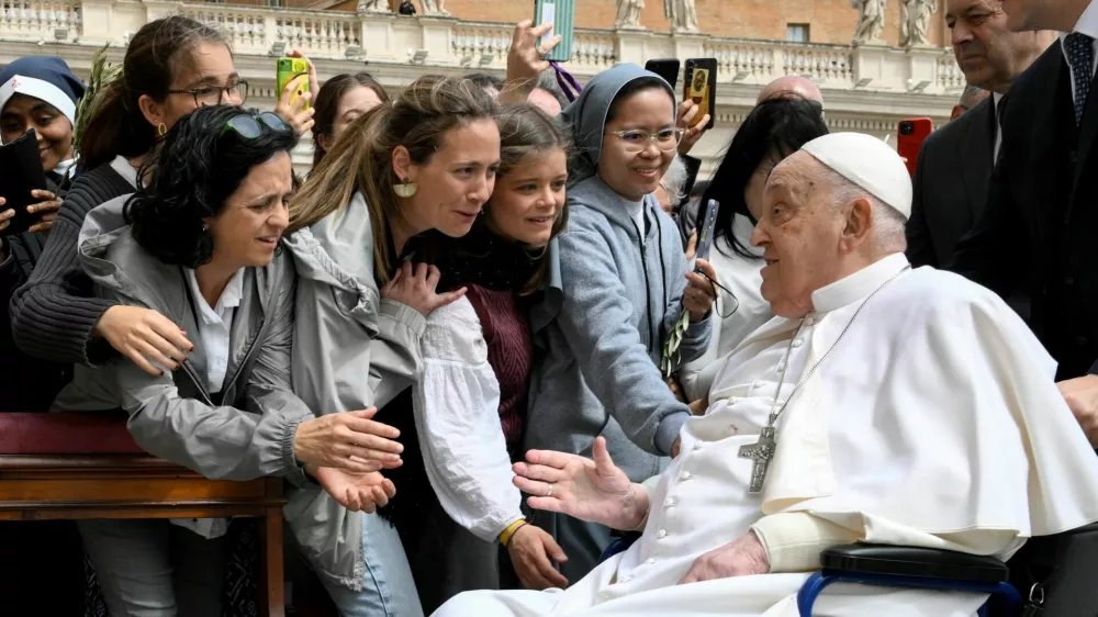 Pope Francis meets with people as he unexpectedly appears during the Palm Sunday Mass in Saint Peter's Square at the Vatican, April 13, 2024.  Vatican Media/&shy;Handout via REUTERS  ATTENTION EDITORS - THIS IMAGE WAS PROVIDED BY A THIRD PARTY.