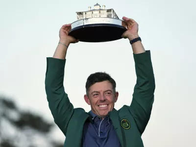 Winner Rory McIlroy, of Northern Ireland, holds the trophy at the Masters golf tournament, Sunday, April 13, 2025, in Augusta, Ga. (AP Photo/Ashley Landis)