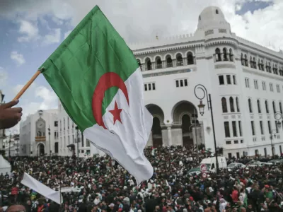 People chant slogans and wave flags during a demonstration in Algiers, Algeria, Wednesday, April 10, 2019. The Algerian senator Abdelkader Bensalah named to temporarily fill the office vacated by former President Abdelaziz Bouteflika said he would act quickly to arrange an "honest and transparent" election to usher in an "Algeria of the future." (AP Photo/Mosa'ab Elshamy)