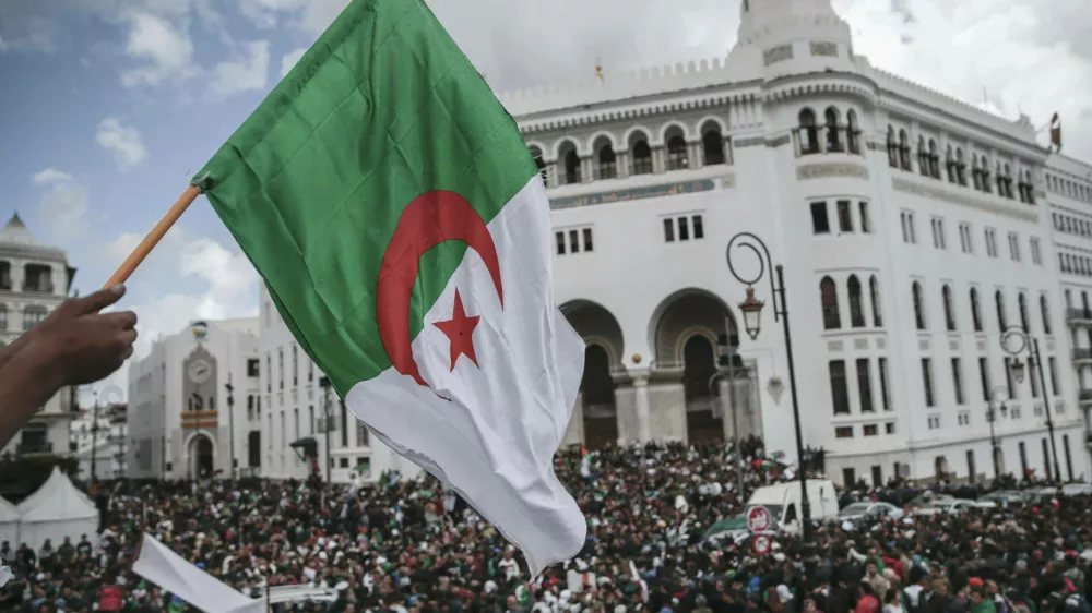 People chant slogans and wave flags during a demonstration in Algiers, Algeria, Wednesday, April 10, 2019. The Algerian senator Abdelkader Bensalah named to temporarily fill the office vacated by former President Abdelaziz Bouteflika said he would act quickly to arrange an "honest and transparent" election to usher in an "Algeria of the future." (AP Photo/Mosa'ab Elshamy)