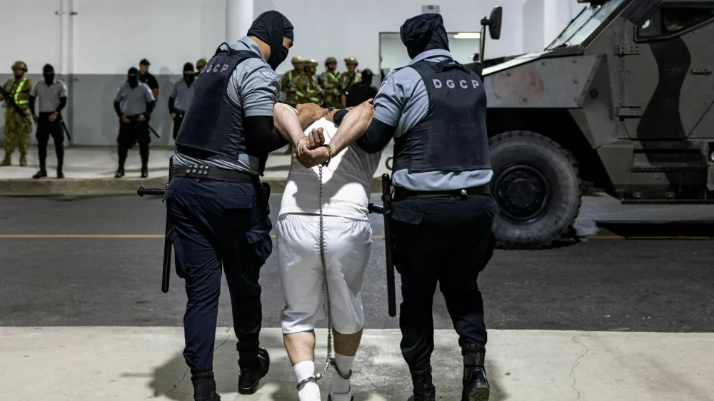 Salvadoran prison guards escort a man as the alleged members of the Venezuelan gang Tren de Aragua and the MS-13 gang recently deported by the U.S. government are to be imprisoned in the Terrorism Confinement Center (CECOT) prison, in Tecoluca, El Salvador April 12, 2025. Secretaria de Prensa de la Presidencia/Handout via REUTERS ATTENTION EDITORS-THIS IMAGE HAS BEEN SUPPLIED BY A THIRD PARTY. NO RESALES. NO ARCHIVES.