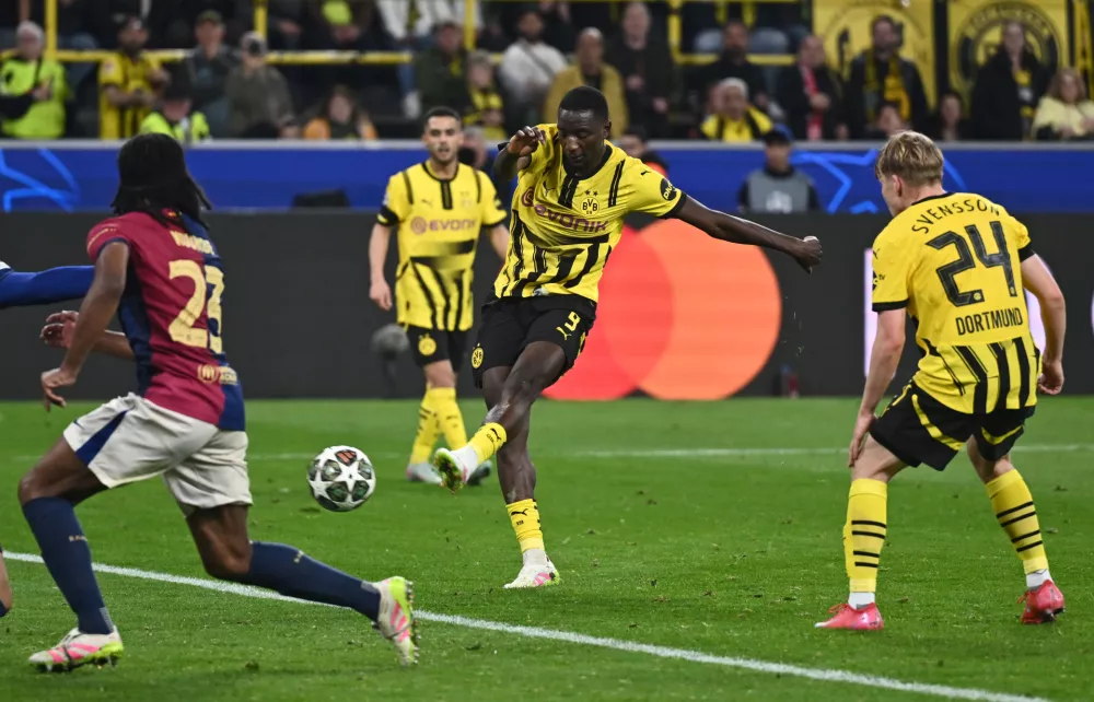 15 April 2025, North Rhine-Westphalia, Dortmund: Dortmund's Serhou Guirassy (C) scores his side's third goal during the UEFA Champions League quarter-final second leg soccer match between Borussia Dortmund and FC Barcelona at the Signal Iduna Park. Photo: Bernd Thissen/dpa
