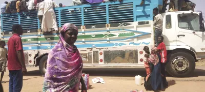 FILE - People board a truck as they leave Khartoum, Sudan, on June 19, 2023. (AP Photo, File)