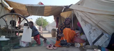 Awadiya Al-Day Ibrahim prepares meal for her family with World Food Programme (WFP) food supplies at a tent, in Kassala, Sudan March 19, 2025, in this screengrab obtained from a video. WFP/Handout via REUTERS THIS IMAGE HAS BEEN SUPPLIED BY A THIRD PARTY