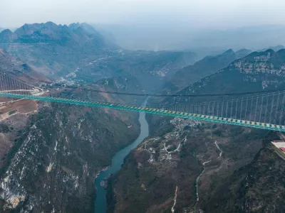 ZHENFENG, Jan. 17, 2025 -- An aerial drone photo taken on Jan. 17, 2025 shows a view of the Huajiang Grand Canyon Bridge in southwest China's Guizhou Province. China on Friday finished the construction of the main structure of the Huajiang Grand Canyon Bridge in its southwestern Guizhou Province, which is set to become the world's tallest bridge. A project of Guizhou Transportation Investment Group Co., Ltd., the suspension bridge has a vertical height of 625 meters from the bridge deck down to the river surface. The 2,890-meter bridge, with a span of 1,420 meters, is also the world's largest span bridge to be built in a mountainous area.,Image: 954481489, License: Rights-managed, Restrictions:, Model Release: noFoto: Profimedia