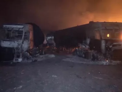 Fire and smoke rise next to charred vehicles following, what Al Masirah TV said, was a U.S. strike on the Ras Isa fuel port, Yemen, in this screengrab from a handout video released on April 18, 2025. Al-Masirah TV /Handout via REUTERS  THIS IMAGE HAS BEEN SUPPLIED BY A THIRD PARTY. NO RESALES. NO ARCHIVES