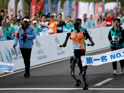 Tiangong Ultra, a humanoid robot runs across the finish line while securing the first position during the E-Town Humanoid Robot Half Marathon, in Beijing, China April 19, 2025. REUTERS/Tingshu Wang