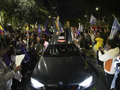 Supporters of President Daniel Noboa celebrate early returns showing him in the lead in the presidential election runoff in Quito, Ecuador, Sunday, April 13, 2025. (AP Photo/Carlos Noriega)