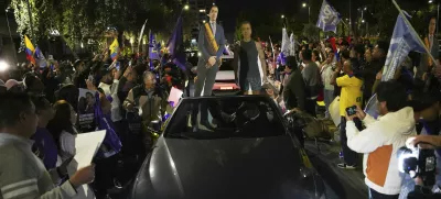 Supporters of President Daniel Noboa celebrate early returns showing him in the lead in the presidential election runoff in Quito, Ecuador, Sunday, April 13, 2025. (AP Photo/Carlos Noriega)