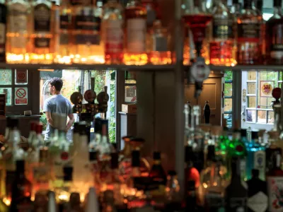 Staff members stand by the entrance of the Red Lion and Sun in London, Britain, August 30, 2022. REUTERS/May James