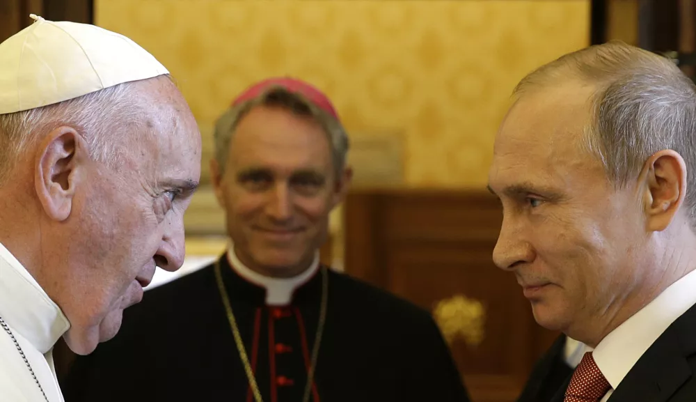 FILE - Pope Francis meets Russian President Vladimir Putin on the occasion of a private audience at the Vatican, June 10, 2015. (AP Photo/Gregorio Borgia, Pool, File)