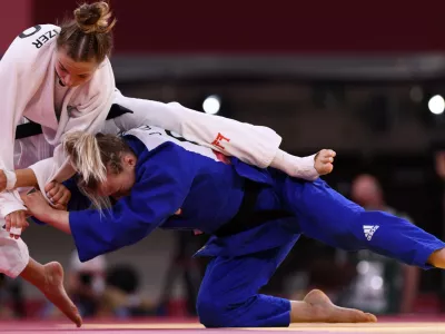 Tokyo 2020 Olympics - Judo - Women's 57kg - Bronze medal match - Nippon Budokan - Tokyo, Japan - July 26, 2021. Kaja Kajzer of Slovenia in action against Jessica Klimkait of Canada REUTERS/Annegret Hilse