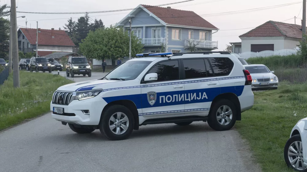 A police vehicle blocks the entrance to the village of Dubona, some 40 kilometers south of Belgrade, Serbia, Friday, May 5, 2023. A shooter killed multiple people and wounded more in a drive-by attack late Thursday in Serbia's second such mass killing in two days, state television reported. (AP Photo/Marko Drobnjakovic)