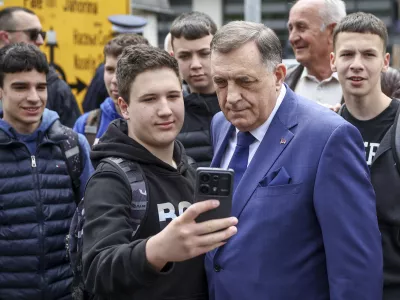 Bosnian Serb President Milorad Dodik, poses for a photo with his supporters at the opening ceremony of the rectory building in Istocno Sarajevo, Bosnia, Thursday, April 24, 2025. (AP Photo/Armin Durgut)