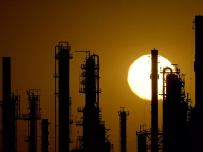 FILE - The CHS oil refinery is silhouetted against the setting sun, Sept. 28, 2024, in McPherson, Kan. (AP Photo/Charlie Riedel, file)