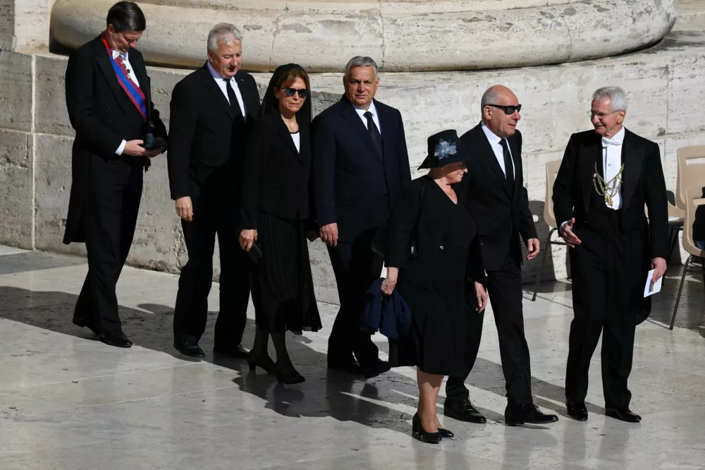 Hungary's Prime Minister Viktor Orban and his wife Aniko Levai walk ahead of the funeral Mass of Pope Francis, at the Vatican, April 26, 2025. REUTERS/Kai Pfaffenbach