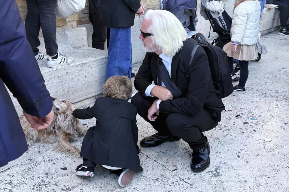 Julian Assange attends the funeral of Pope Francis in St. Peter's Square at the Vatican, Saturday, April 26, 2025. (Giusi Brega/LaPresse via AP)