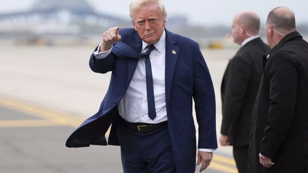 President Donald Trump points as he arrives at Newark Liberty International Airport in Newark, N.J., Saturday, April 26, 2025, upon returning from a trip to attend the funeral of Pope Francis at the Vatican. (AP Photo/Evan Vucci)