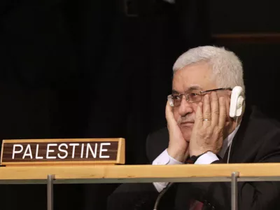 Palestinian President Mahmoud Abbas holds his hands to his face as U.S. President Barack Obama speaks during the 66th session of the General Assembly at United Nations headquarters Wednesday, Sept. 21, 2011. (AP Photo/Seth Wenig)