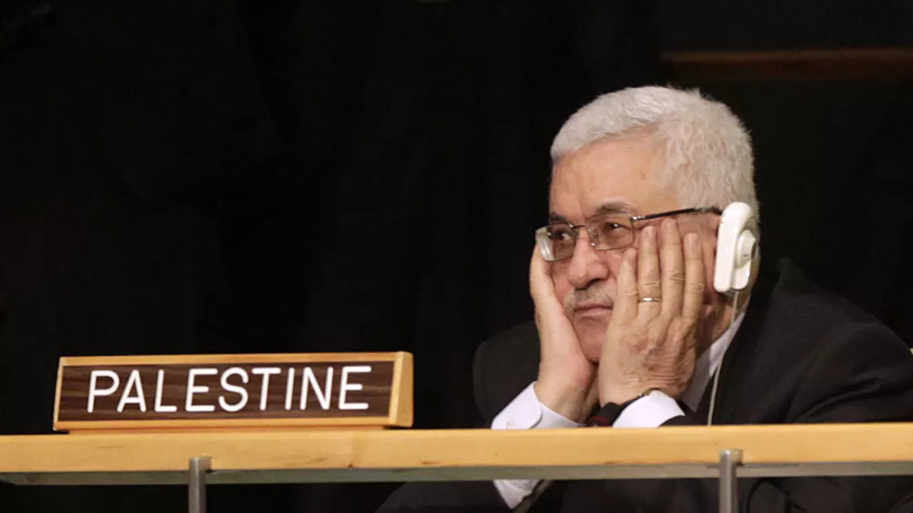 Palestinian President Mahmoud Abbas holds his hands to his face as U.S. President Barack Obama speaks during the 66th session of the General Assembly at United Nations headquarters Wednesday, Sept. 21, 2011. (AP Photo/Seth Wenig)